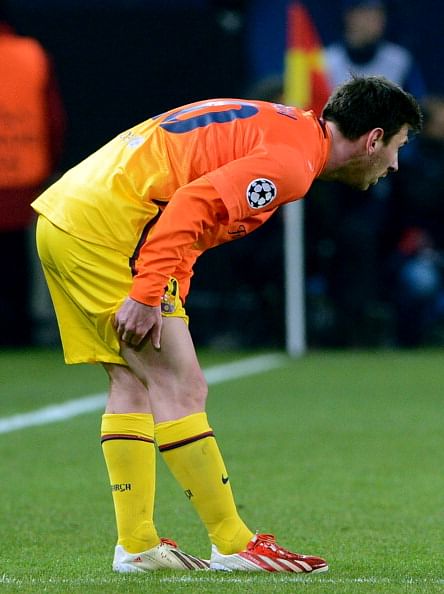 Barcelona's Argentinian forward Lionel Messi holds his leg during the Champions League quarter-final football match between Paris Saint-Germain and Barcelona at the Parc des Princes stadium in Paris on April 2, 2013. AFP PHOTO / FRANCK FIFE (Photo credit should read FRANCK FIFE/AFP/Getty Images)